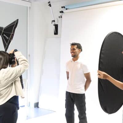 Student having their photo taken by a photography student