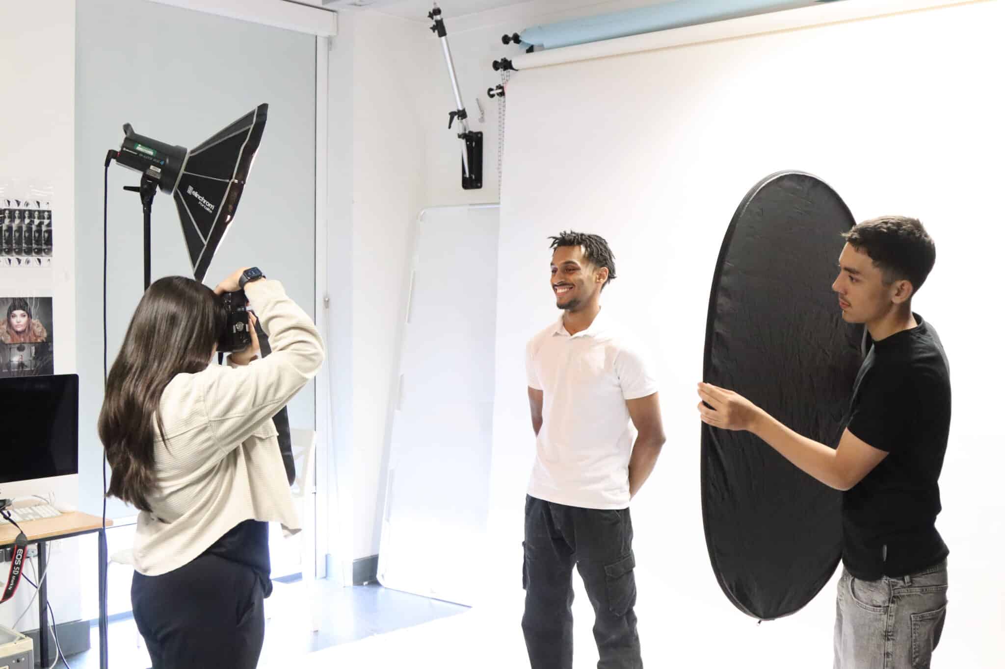 Student having their photo taken by a photography student