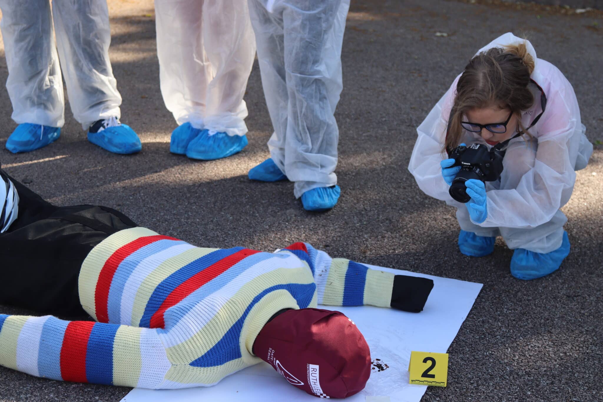 student taking photo of dummy