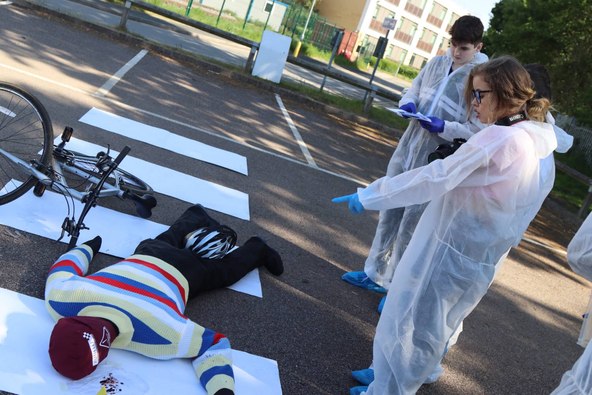 student pointing at crime scene