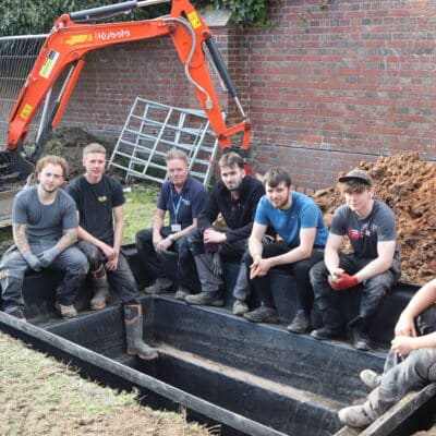 The bricklaying apprentices sitting in the duck pond