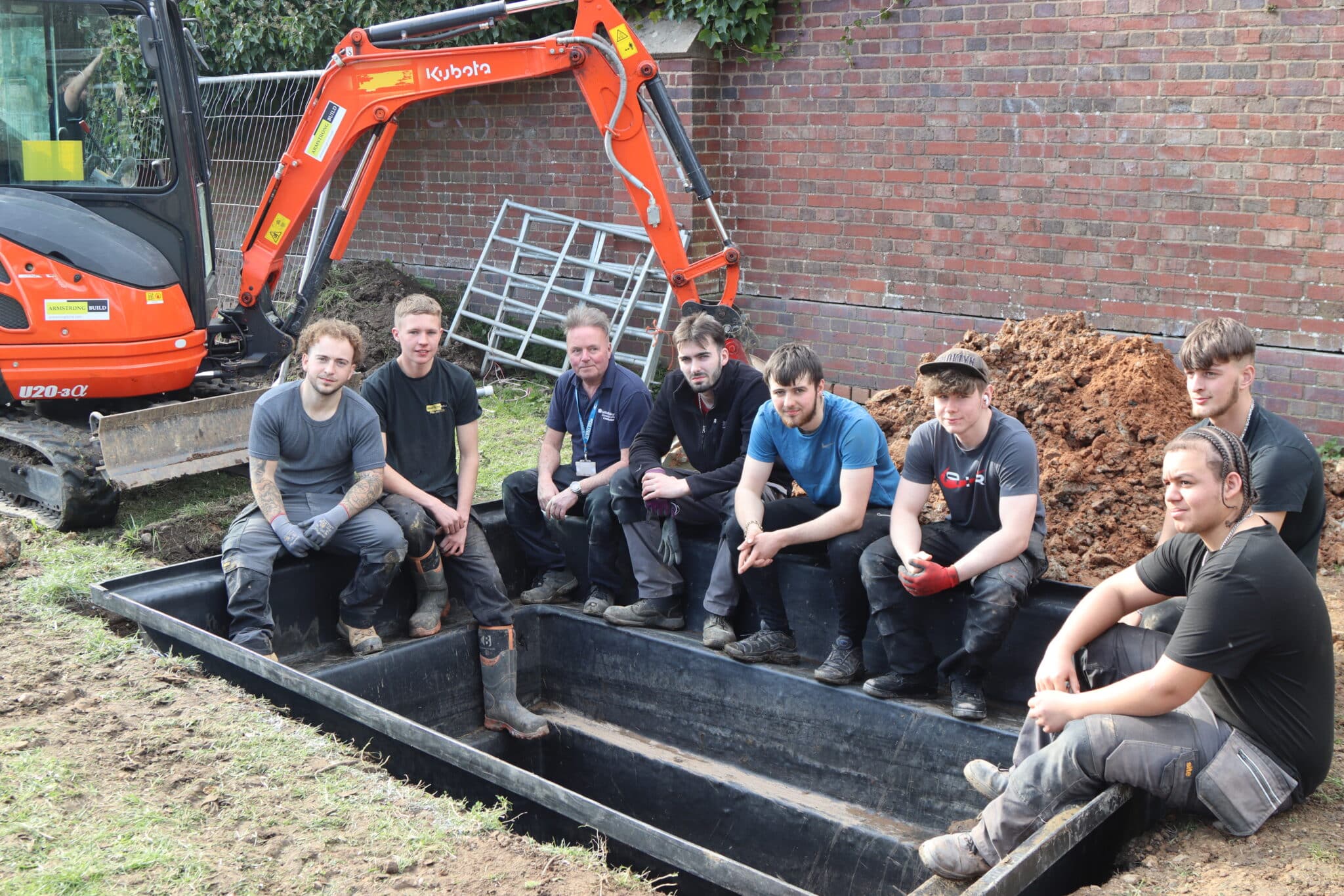 The bricklaying apprentices sitting in the duck pond