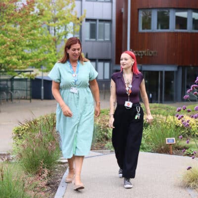 sasha and rebecca talking as they walk