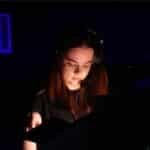 Eden with headphones on, working on set