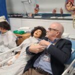 pete lying in the health suite bed with reactive dummy