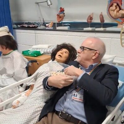 pete lying in the health suite bed with reactive dummy