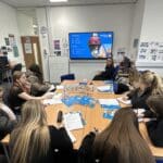 classroom listening to Tracy as she speaks in front of screen