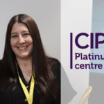 Student smiling at camera with CIPD logo