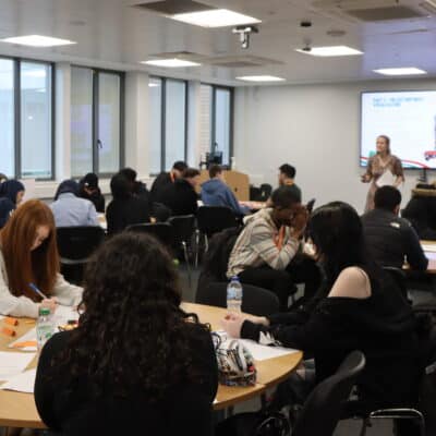 students in a classroom with a presentation