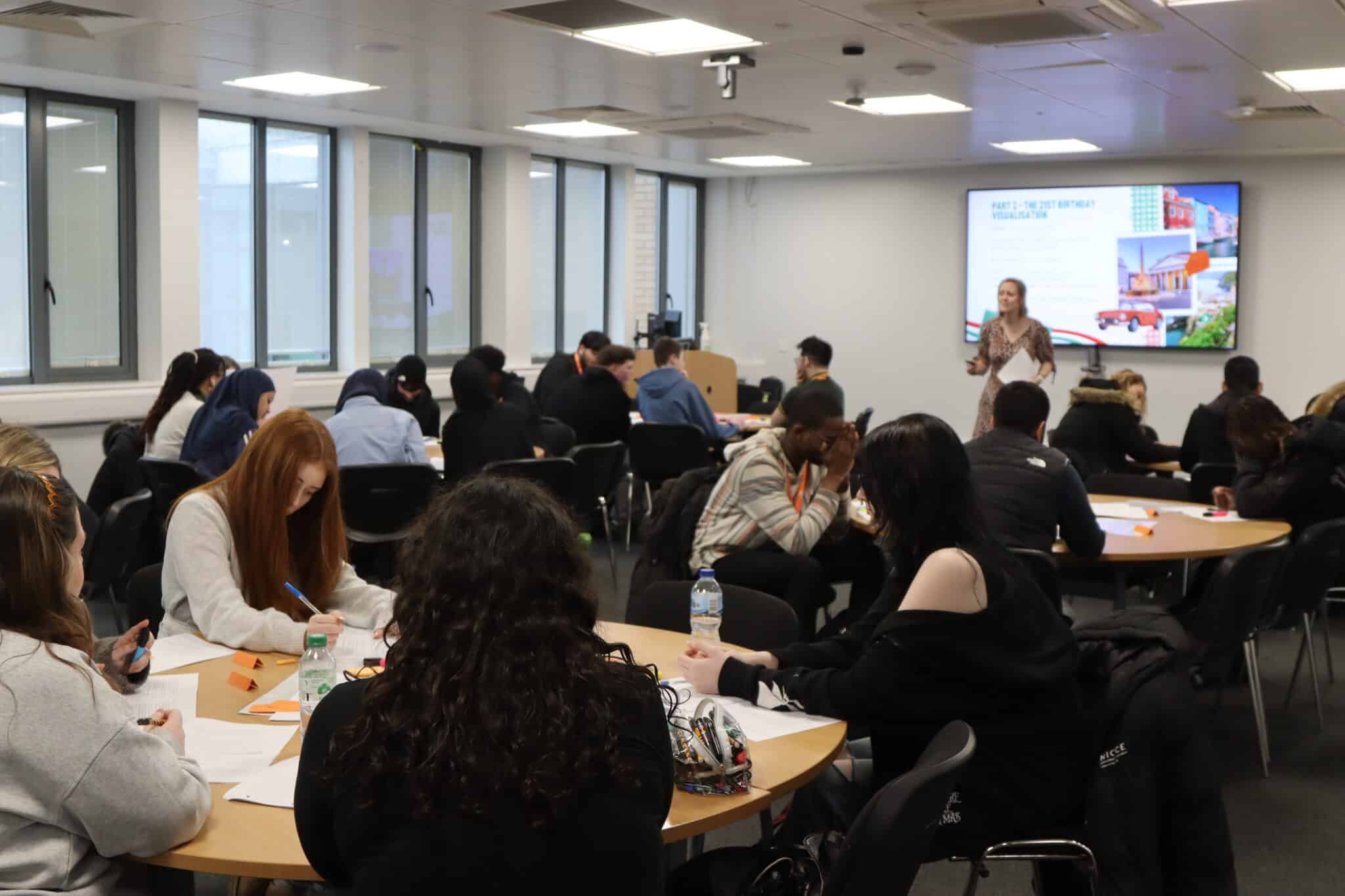 students in a classroom with a presentation