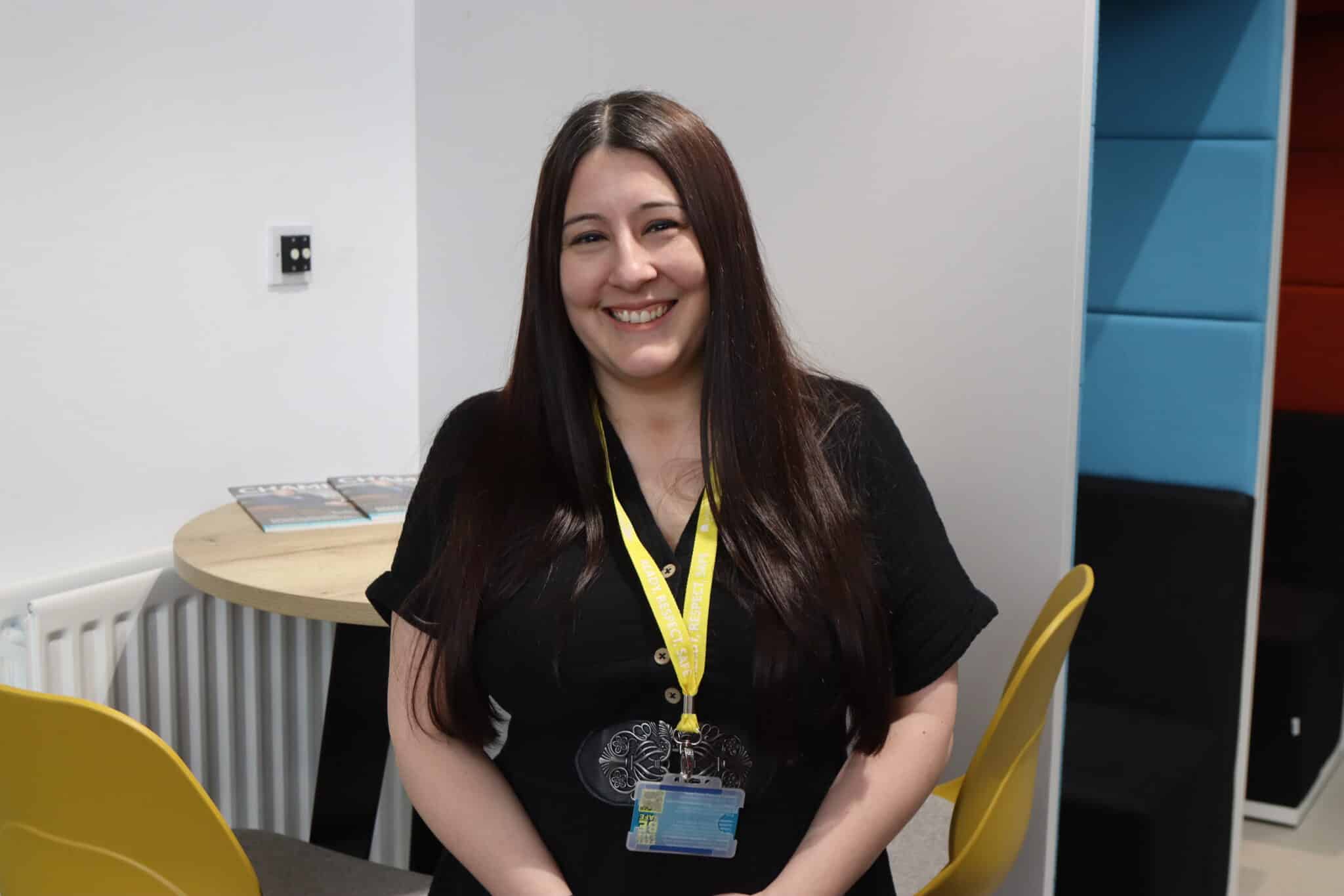 Student with brown hair smiling at the camera