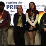 4 students smiling the camera