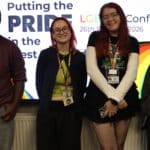 4 students smiling at the camera