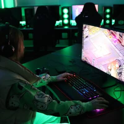 Student sat in green lighting whilst sat at a computer