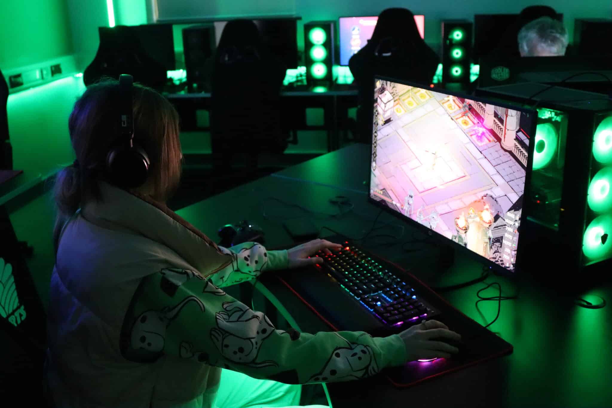 Student sat in green lighting whilst sat at a computer