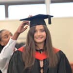Mia having her cap fitted at graduation