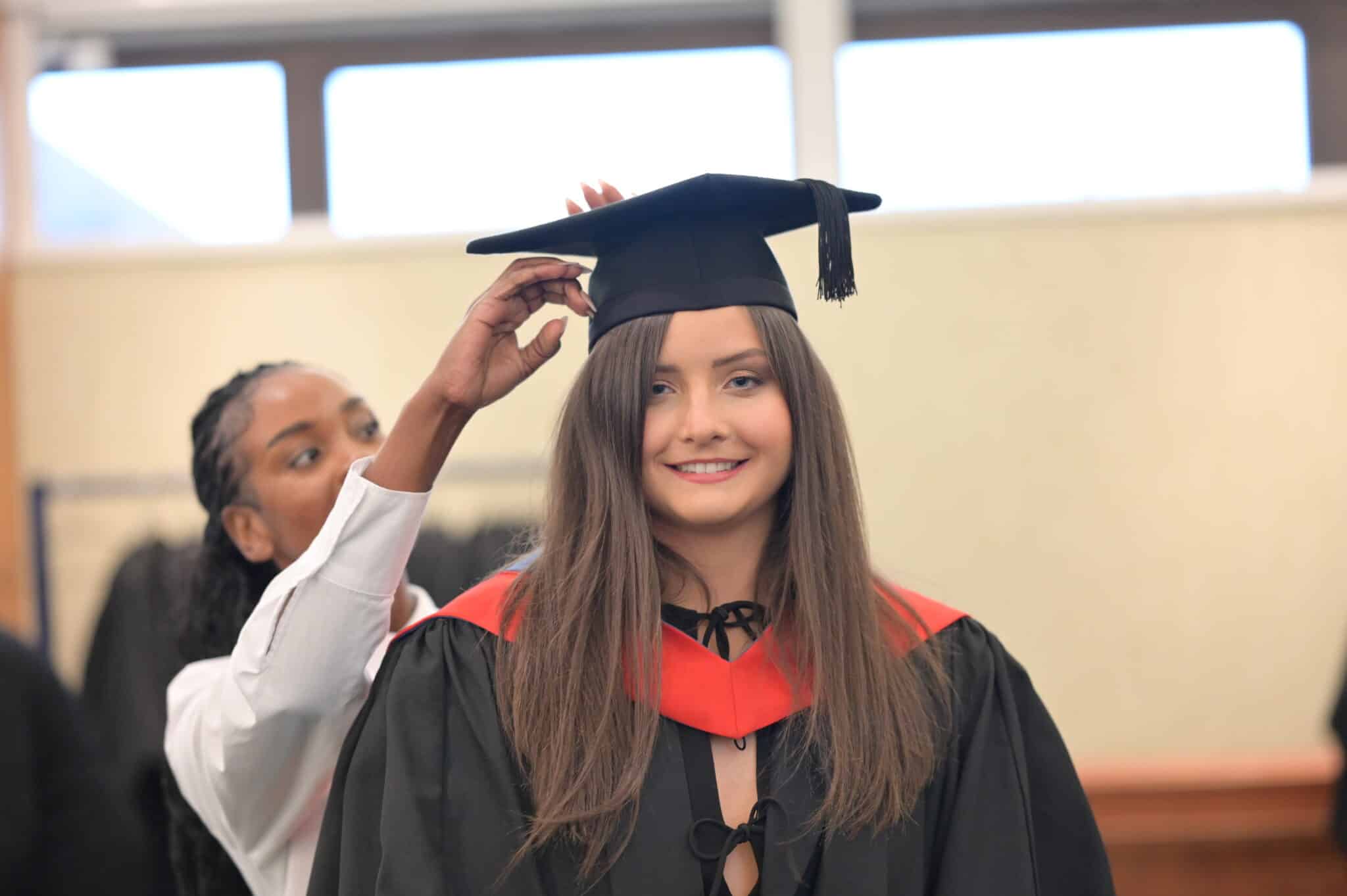 Mia having her cap fitted at graduation