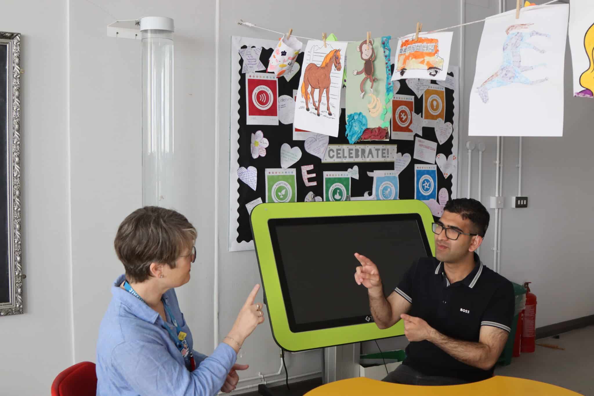 Shoaib and Deaf Support Co-ordinator Claire Whatmore doing sign language