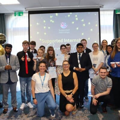 students and staff in front of a screen