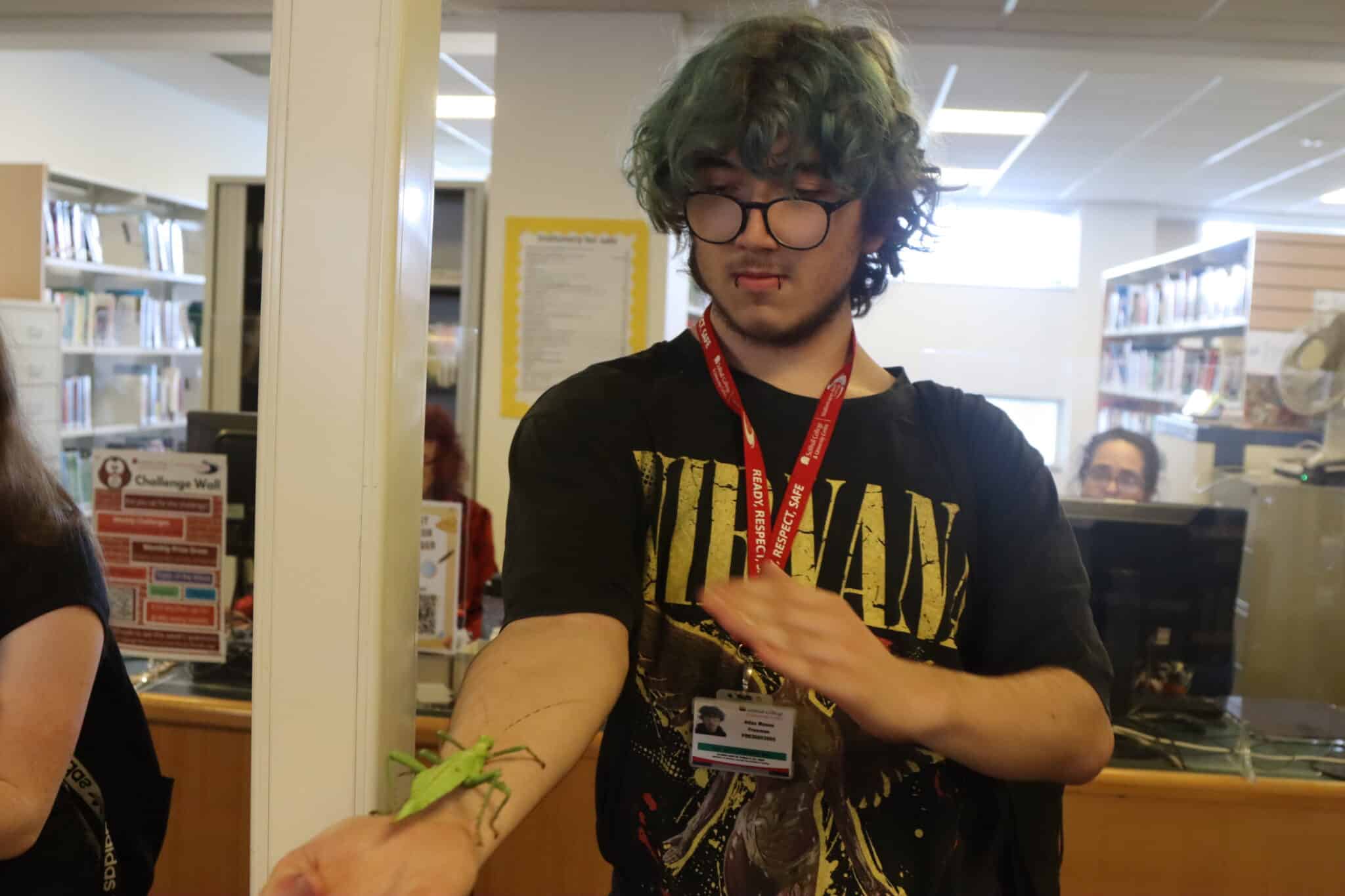students with a stick insect on his arm